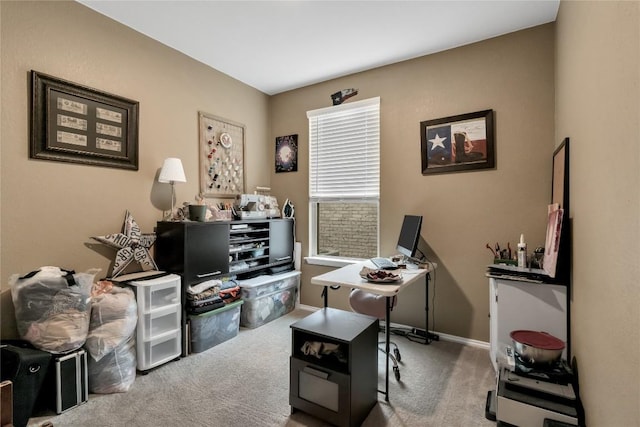 carpeted office space featuring baseboards