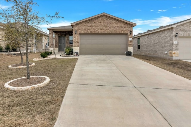 view of front facade with a garage, concrete driveway, and brick siding