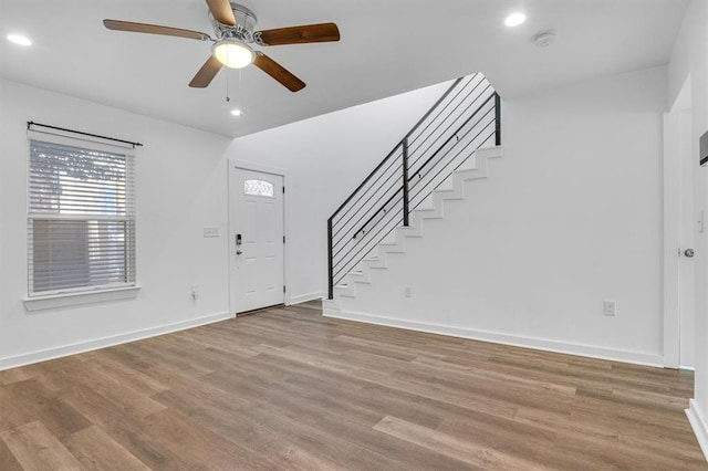 entryway featuring light wood-style floors, recessed lighting, stairway, and baseboards