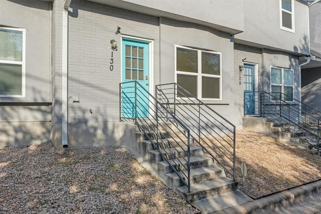 view of exterior entry with brick siding