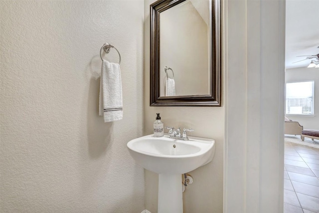 bathroom featuring ceiling fan and tile patterned floors