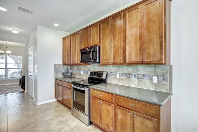 kitchen with visible vents, appliances with stainless steel finishes, and brown cabinets