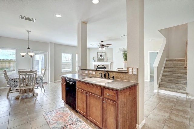 kitchen with light tile patterned flooring, a sink, visible vents, dishwasher, and brown cabinetry