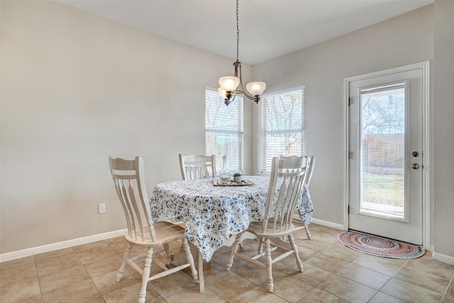 tiled dining area with baseboards and a notable chandelier