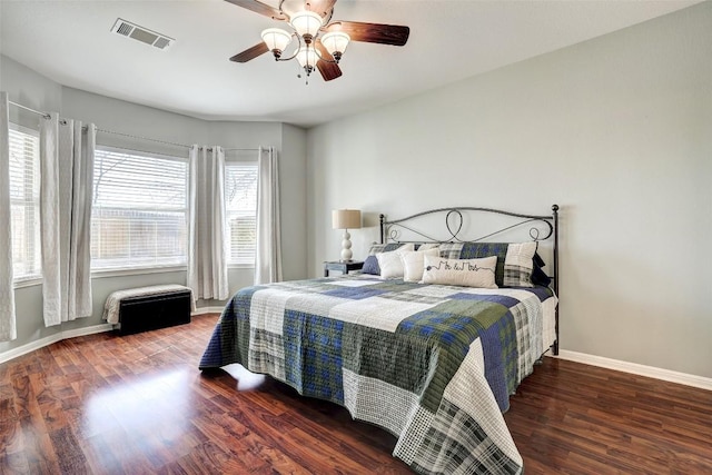 bedroom featuring a ceiling fan, baseboards, visible vents, and wood finished floors