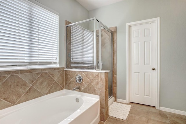 full bath featuring a garden tub, a shower stall, baseboards, and tile patterned floors