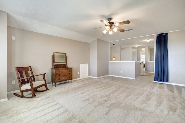 living area featuring visible vents, ceiling fan, light carpet, and baseboards