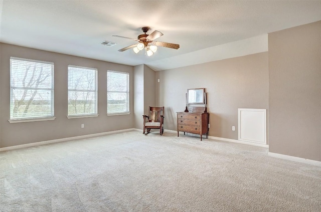 unfurnished room featuring baseboards, ceiling fan, visible vents, and carpet flooring