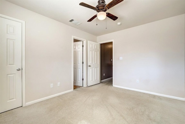 unfurnished bedroom with baseboards, visible vents, ceiling fan, and carpet flooring