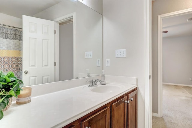 full bathroom with vanity and baseboards