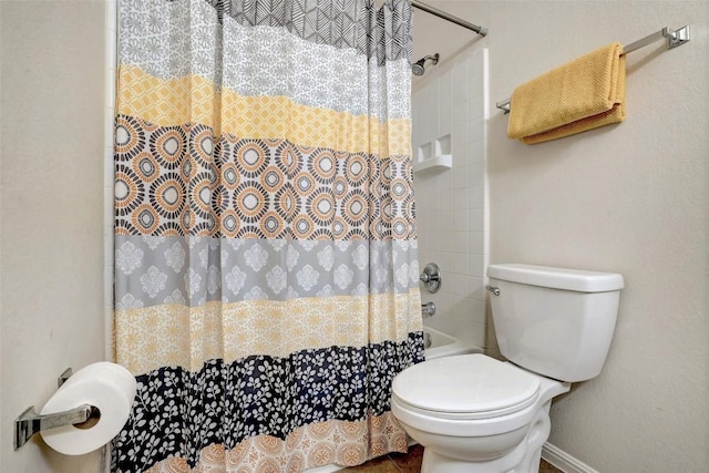 bathroom featuring toilet and a shower with curtain