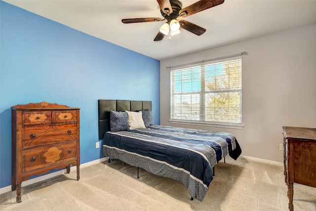 bedroom with light carpet, ceiling fan, and baseboards