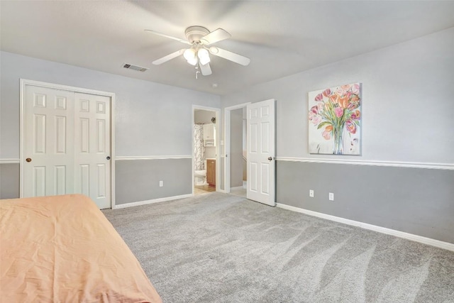 unfurnished bedroom with a closet, carpet flooring, visible vents, and baseboards