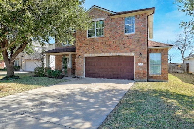 traditional-style house with concrete driveway, a front lawn, fence, and brick siding