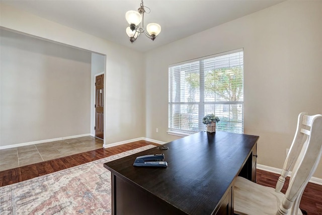 home office with a chandelier, baseboards, and wood finished floors