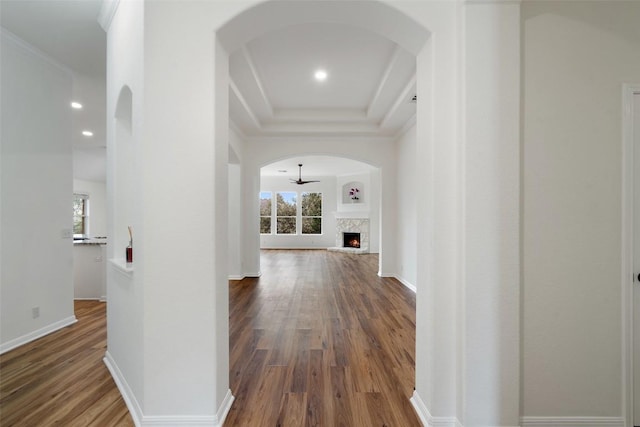 corridor with a healthy amount of sunlight, baseboards, wood finished floors, and recessed lighting