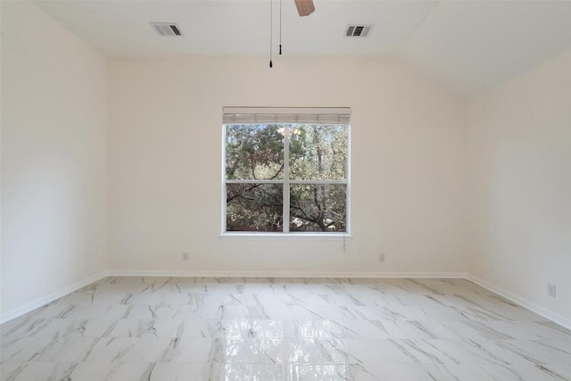 spare room featuring vaulted ceiling, marble finish floor, visible vents, and baseboards