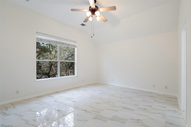 spare room with lofted ceiling, marble finish floor, visible vents, and baseboards