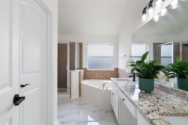 bathroom with marble finish floor, double vanity, a sink, and a shower stall