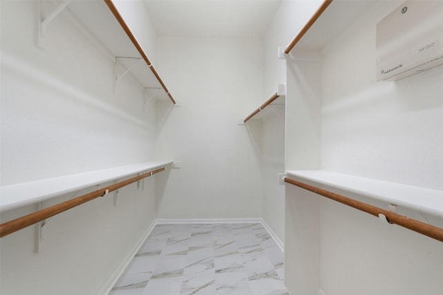 spacious closet with marble finish floor