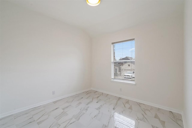 spare room with marble finish floor and baseboards