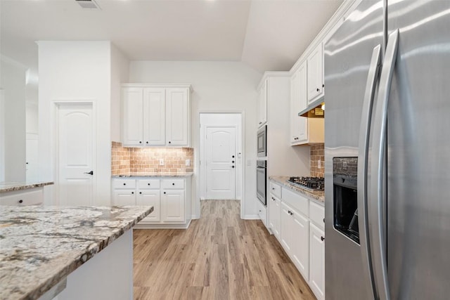 kitchen featuring light wood-style flooring, appliances with stainless steel finishes, light stone counters, under cabinet range hood, and white cabinetry