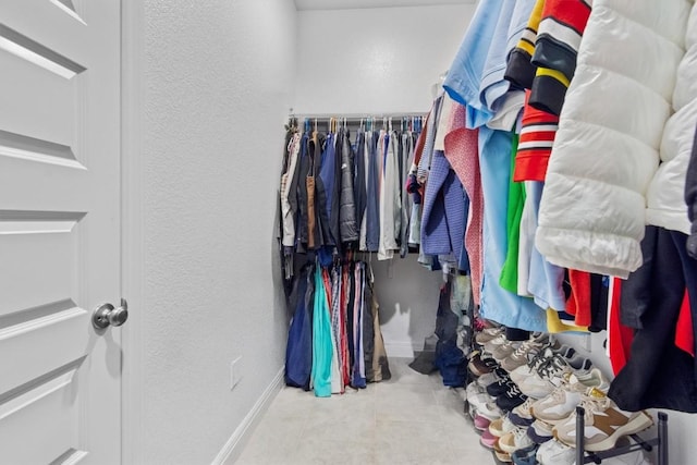 walk in closet with tile patterned flooring