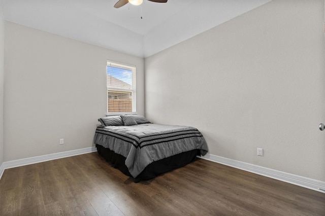 bedroom featuring ceiling fan, baseboards, and wood finished floors