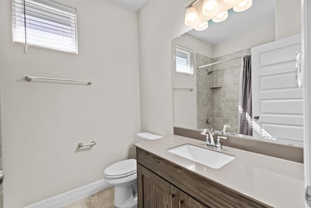 bathroom with baseboards, a shower with shower curtain, toilet, tile patterned floors, and vanity