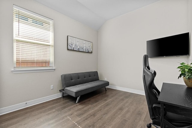 office space featuring lofted ceiling, baseboards, and wood finished floors