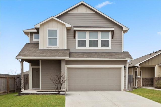 view of front of home with concrete driveway, an attached garage, board and batten siding, a front yard, and fence