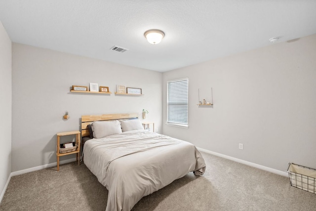 carpeted bedroom with baseboards and visible vents