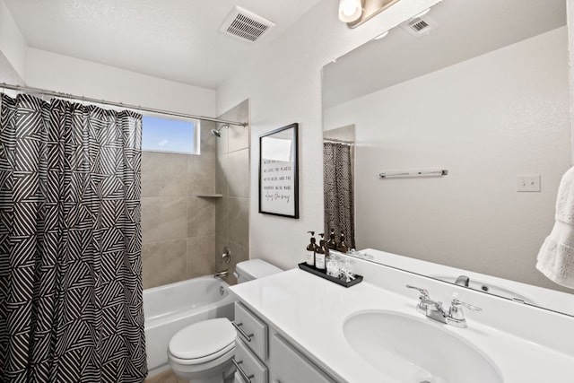 bathroom featuring toilet, visible vents, shower / bath combo with shower curtain, and vanity