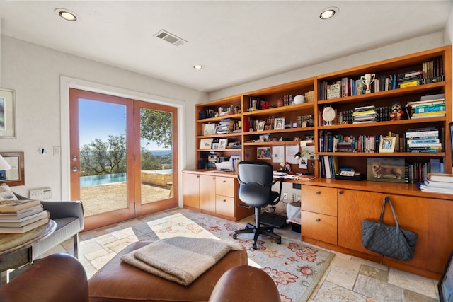 office space featuring recessed lighting, visible vents, and stone tile floors