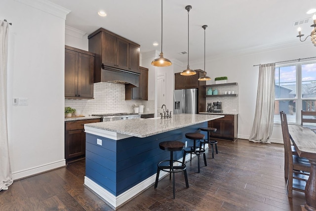 kitchen with dark wood-style floors, crown molding, stainless steel refrigerator with ice dispenser, open shelves, and dark brown cabinets