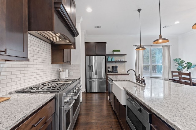 kitchen with custom exhaust hood, appliances with stainless steel finishes, ornamental molding, dark brown cabinetry, and a sink