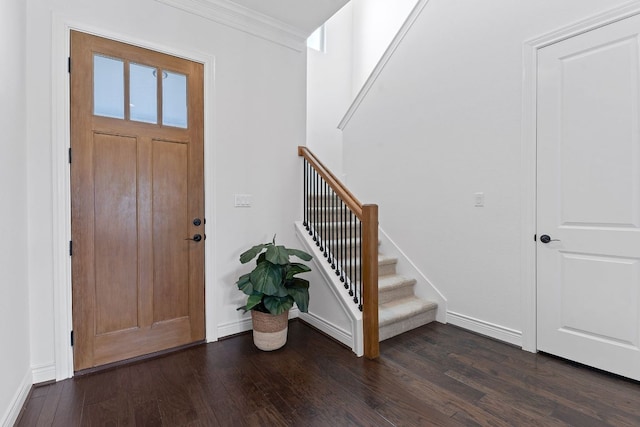 entryway featuring baseboards, stairs, ornamental molding, and wood finished floors