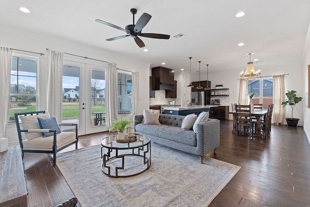 living area with plenty of natural light, french doors, and dark wood finished floors