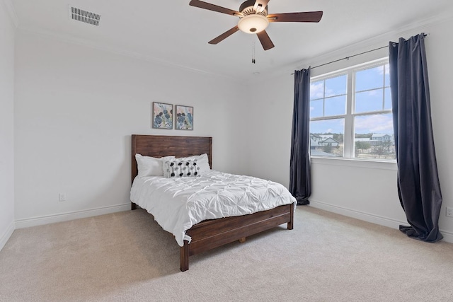 bedroom featuring light colored carpet, crown molding, visible vents, and baseboards