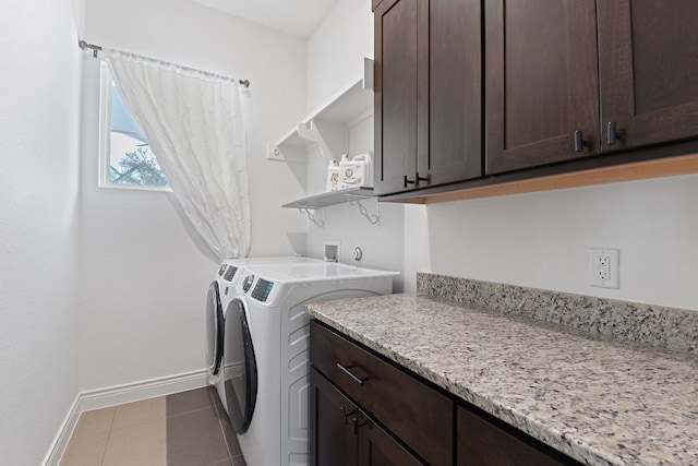 laundry area with tile patterned flooring, cabinet space, baseboards, and separate washer and dryer