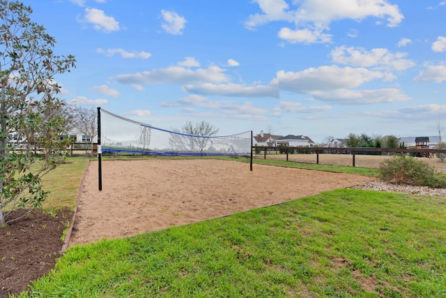 surrounding community featuring a yard and volleyball court