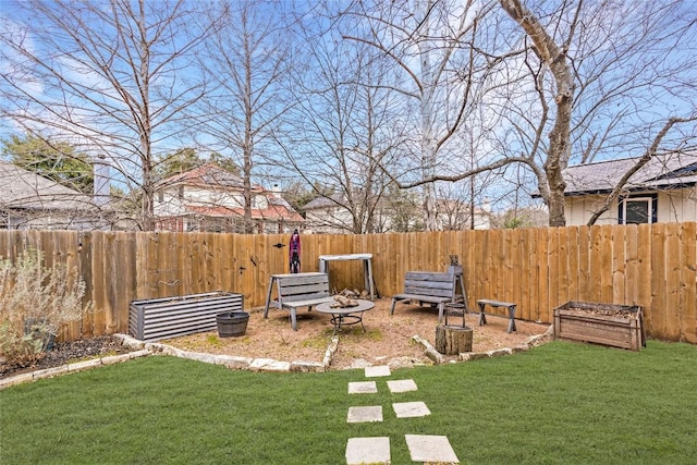 view of yard with an outdoor fire pit and a fenced backyard