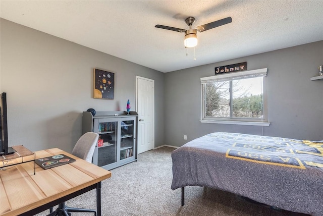 bedroom featuring carpet floors, ceiling fan, baseboards, and a textured ceiling