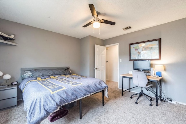 carpeted bedroom with baseboards, visible vents, and ceiling fan