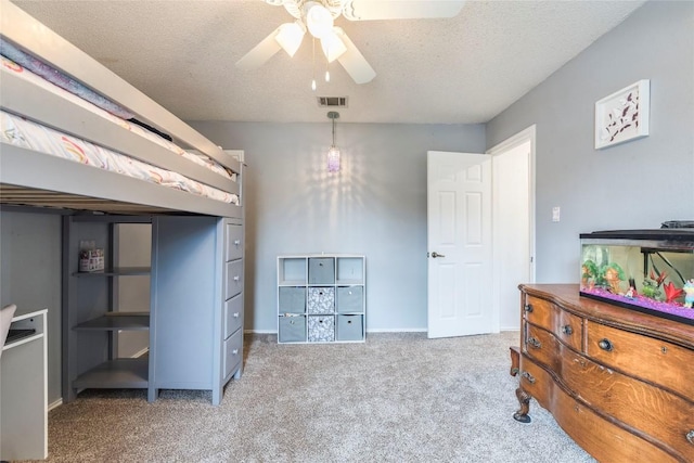 bedroom featuring baseboards, visible vents, a ceiling fan, a textured ceiling, and carpet flooring