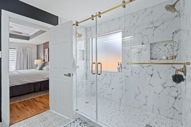 ensuite bathroom with ensuite bath, a marble finish shower, ornamental molding, and a tray ceiling