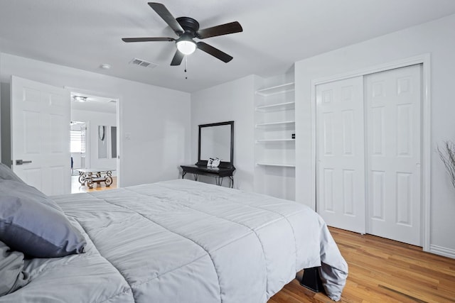 bedroom featuring visible vents, ceiling fan, a closet, and light wood-style flooring