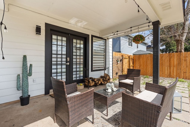 view of patio / terrace with fence, outdoor lounge area, and french doors