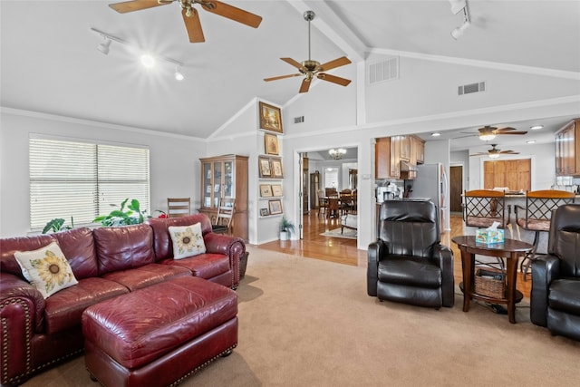 living area featuring high vaulted ceiling, visible vents, beamed ceiling, and light colored carpet