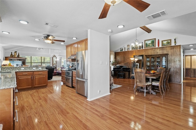 kitchen featuring open floor plan, appliances with stainless steel finishes, light wood finished floors, and visible vents